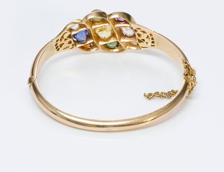 Navaratna Gemstone Bracelet.Antique Navaratna multi-color gemstone yellow gold bangle bracelet. Wearing the nine gems is said to provide an astrological balance and benefit to the wearer. According to Hindu astrology life on earth is influenced by the navagrahas, or nine influencers. "nine celestial bodies of universe ". Yellow Gold Bangle Bracelet With Gemstone Accents, Heirloom Gemstone Bangle Bracelets, Fine Jewelry Gold Gemstone Bangle Bracelet, Heirloom Gemstone Bangle Bracelet, Heirloom Yellow Gold Gemstone Bracelets, Yellow Gold Oval Bangle With Gemstone, Vintage Gold Bangle With Gemstone, Gold Gemstone Bangle For Festivals, Fine Jewelry Multi-stone Bangle