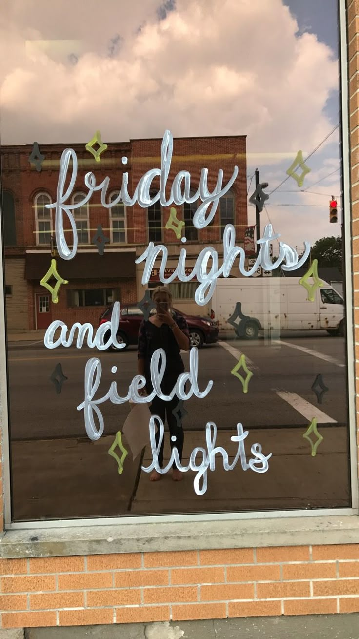 a window with the words friday nights and field lights written in white lettering on it