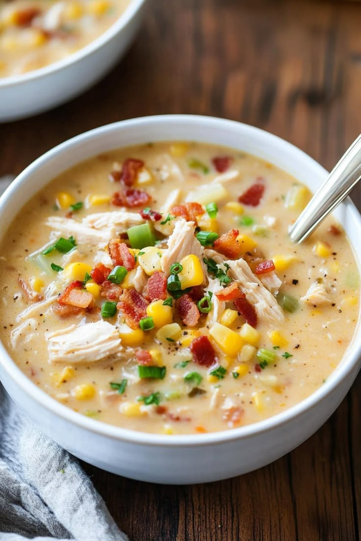 two bowls filled with soup on top of a wooden table