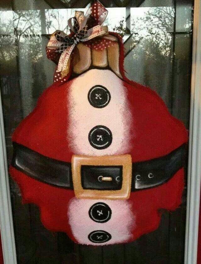 a santa clause door hanger with buttons on it's face and belt around the waist