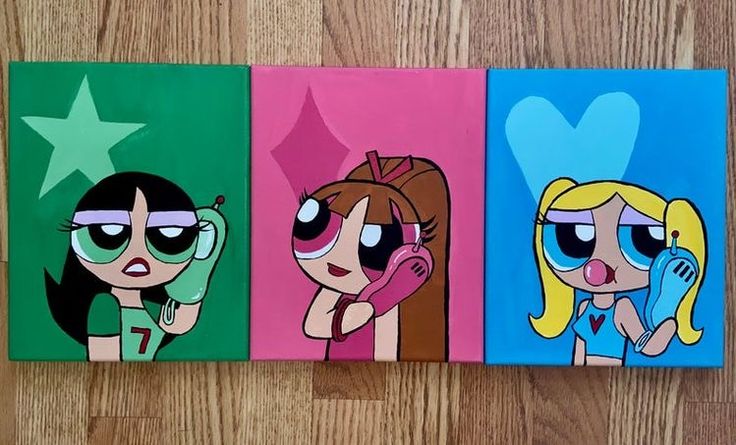 three cartoon characters painted on canvases sitting on a wooden floor