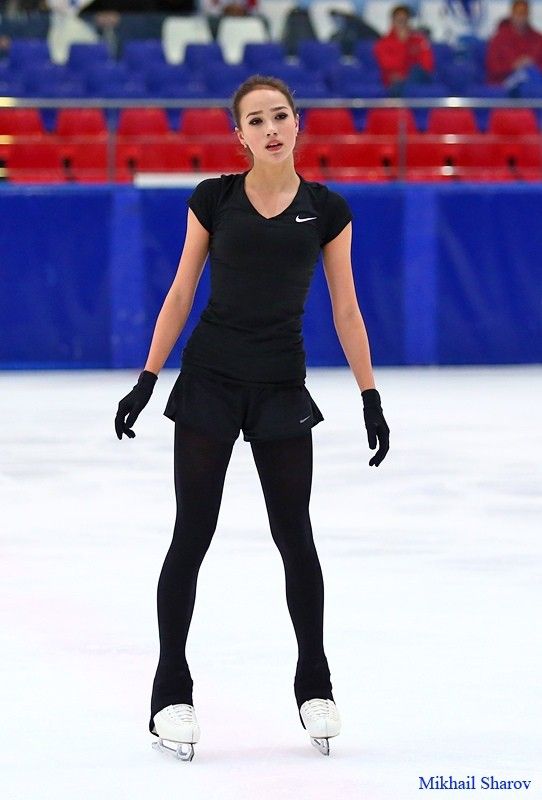 a female figure skating on an ice rink