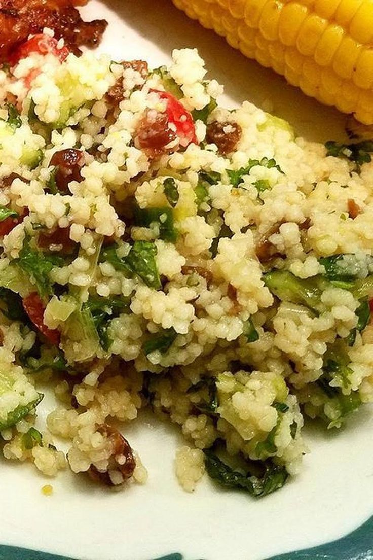 a plate with couscous and corn on the cob