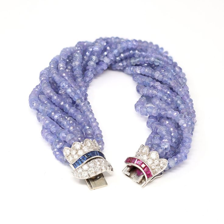 A faceted Ceylon blue Sapphire bead multi strand bracelet with Diamonds Sapphire and Ruby set in 18K white gold clasp, circa 1970. Made in the USA, this beaded bracelet is adorned with an exquisite clasp, presenting 0.80 carats of Ceylon blue sapphires, 0.80 carats Rubies, and 1.80 carats of full cut round Diamonds of G color and VS clarity. The clasp's sinuous lines and arched motifs compliment the strands of natural faceted beads completing the ensemble. Graceful and ultra feminine, this Sapph Ruby Set, Ceylon Blue Sapphire, Ultra Feminine, Multi Strand Bracelet, Blue Sapphire Diamond, Old Jewelry, Strand Bracelet, Sapphire Diamond, Faceted Bead