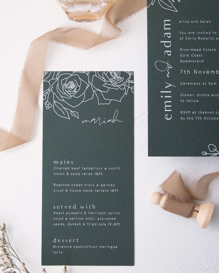 the wedding stationery is laid out on top of each other, along with ribbon and flowers