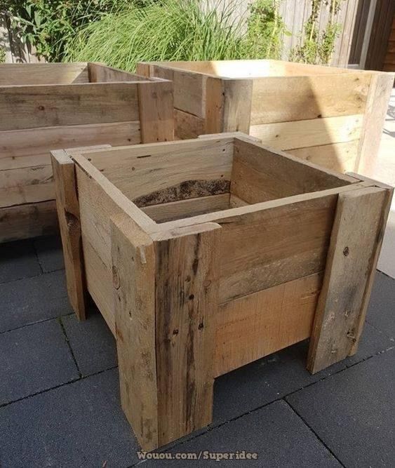 three wooden planters sitting on top of a sidewalk