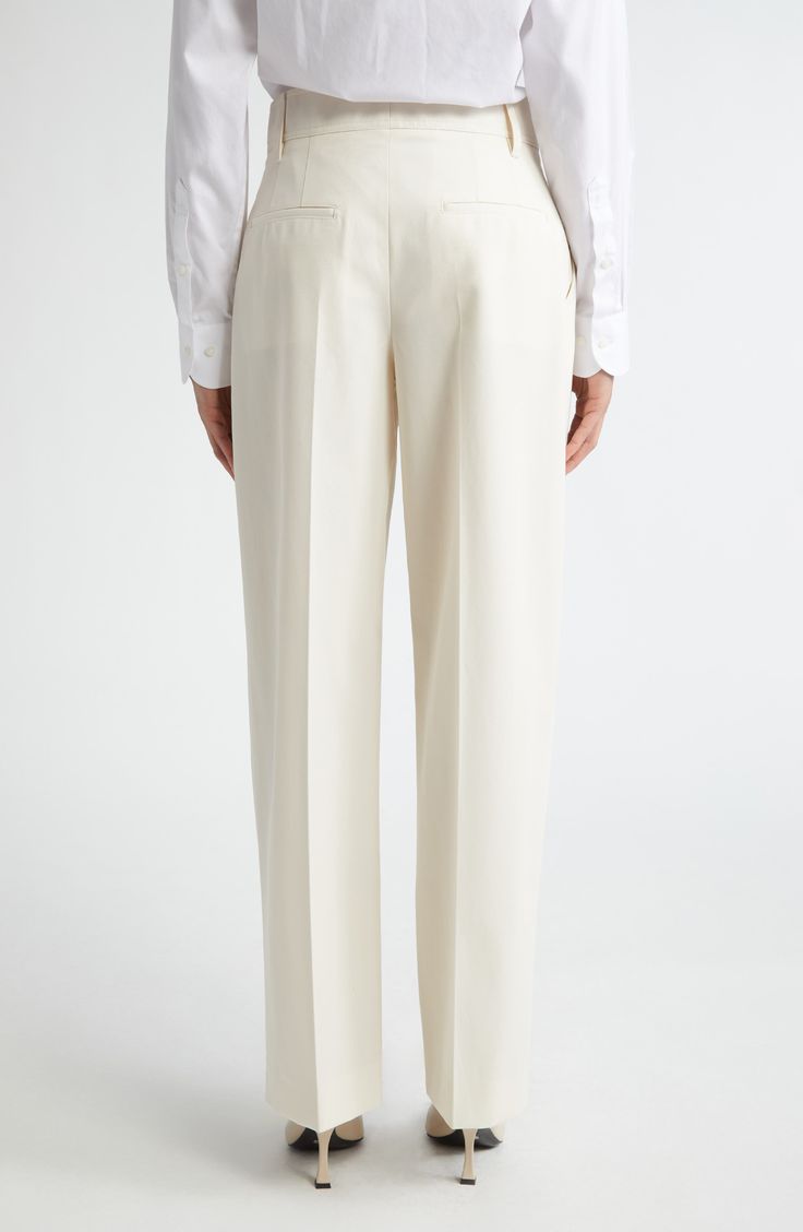 Topstitch detailing subtly calls out the classic lines of these pleat-front trousers made from sturdy, seasonless stretch wool. 30" inseam; 21" leg opening; 10" front rise; 13" back rise (size 10) Zip fly with hook-and-bar closure Belt loops Lined 100% organic cotton Hand wash, line dry Made in the USA Women's Designer Clothing Classic White Dress Pants For Semi-formal, Elegant Cream Pants For Formal Occasions, Elegant Cream Formal Pants, Elegant Tailored Cream Bottoms, Tailored Cream Bottoms For Business Casual, Elegant Tailored Cream Pants, Classic Wool Pants For Spring, Classic Cream Tapered Leg Pants, Classic Straight Leg Cream Dress Pants