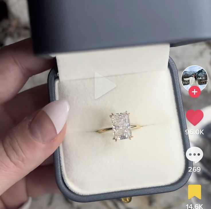 a person holding an engagement ring in their hand with the price tag below it and other icons