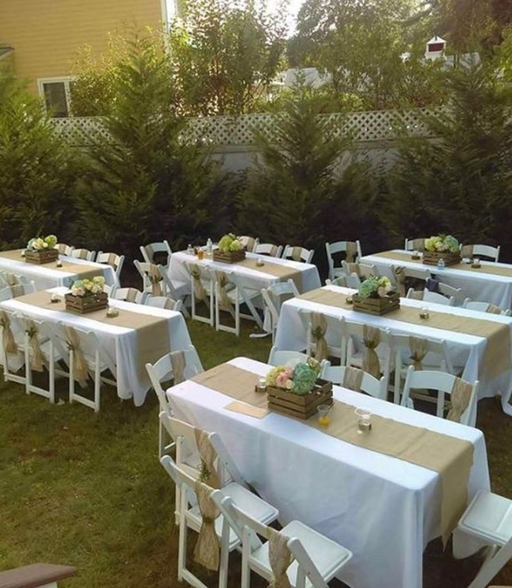 tables and chairs are set up outside in the yard for an outdoor party or gathering