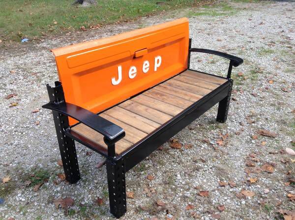 an orange jeep seat sitting on top of a wooden bench