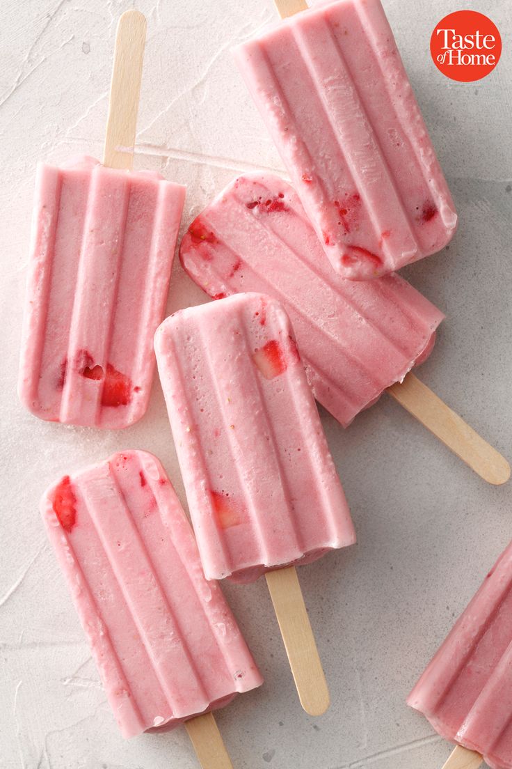 strawberry ice cream popsicles on a white surface