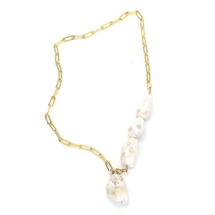 This one's a stunner. Asymmetrical style necklace featuring four sculptural AAA grade cultured baroque pearls that can be worn multiple ways. Adjust the clasp and you can wear it as a drop necklace, dramatic choker with long drop, or wrap it a few times around your wrist for an effortlessly cool bracelet. 14k gold filled. 24" long Elegant Baroque Pearl Jewelry, Elegant Baroque Pearl Necklace With Lobster Clasp, Baroque Pearl Lariat Necklace With Pearl Charm, Pearl Lariat Chain Jewelry, Lariat Necklace With Baroque Pearl Chain, Pearl Lariat Jewelry With Chain Detail, Pearl Lariat With Chain Detail Jewelry, Baroque Pearl Drop Necklace With Pearl Chain, Single Strand Baroque Pearl Briolette Jewelry