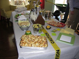 a table topped with lots of food on top of a white table covered in yellow ribbon