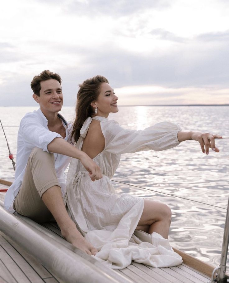 a man and woman sitting on the back of a boat