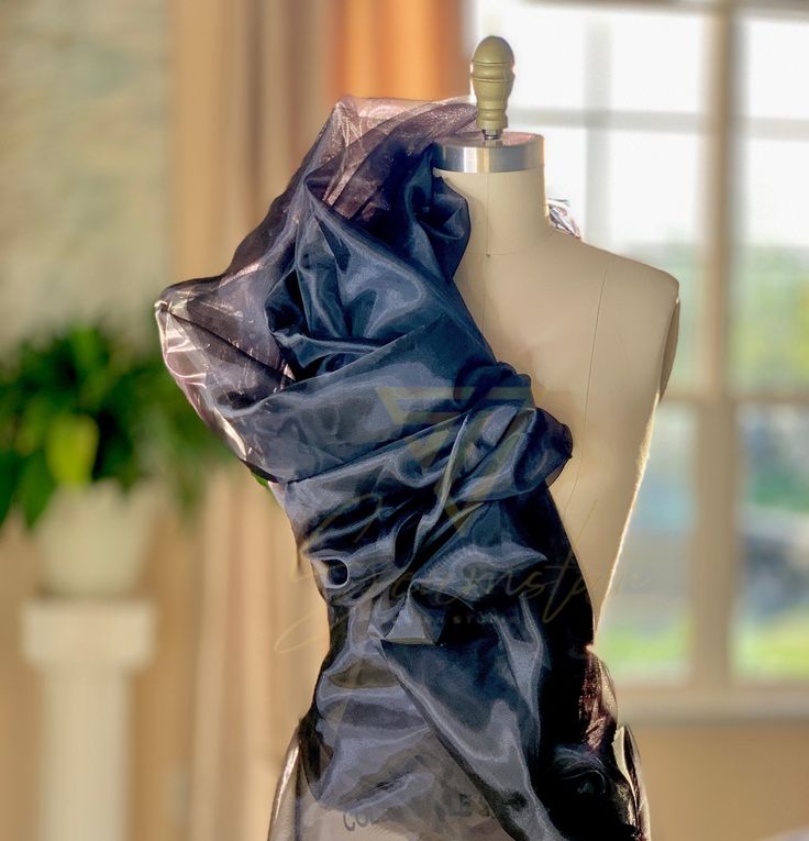 Indulge in the luxurious elegance of our high-quality black organza fabric. This sheer and lightweight fabric is perfect for creating stunning evening gowns, elegant overlays, delicate scarves, and more. The subtle luster of the organza fabric adds a touch of glamour to any project, making it ideal for special occasions and formal wear. With its crisp drape and subtle sheen, this fabric offers endless possibilities for creating breathtaking and sophisticated designs. Elevate your creations with our exquisite organza fabric and bring your vision to life. Width: 59 inches Gowns Elegant, Evening Gowns Elegant, Organza Fabric, Endless Possibilities, Fabric By The Yard, Formal Wear, Wedding Shop, Lightweight Fabric, Evening Gowns