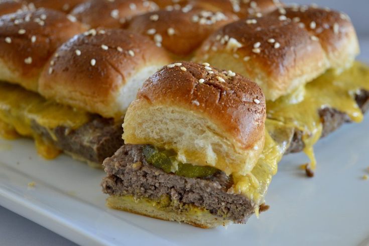 the sandwich is cut in half and ready to be eaten on the plate for consumption