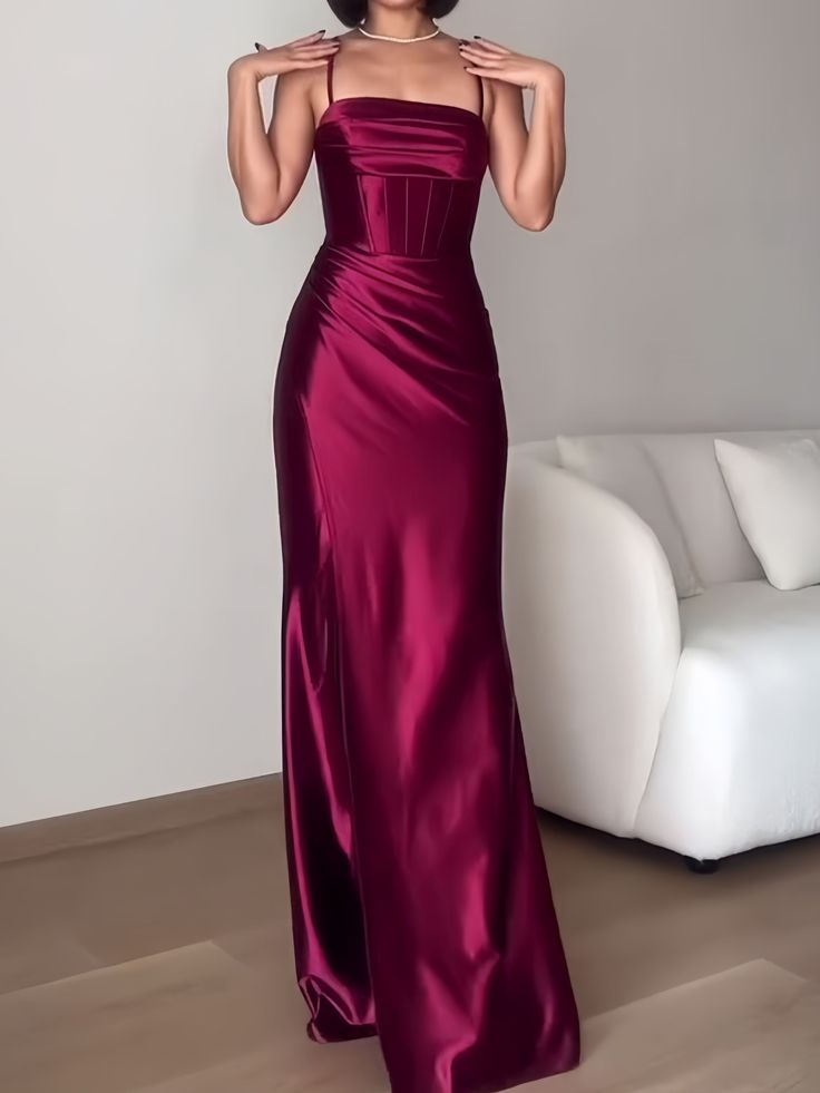 Lavishly ornate, this burgundy satin dress is a masterpiece of design and sophistication. The square neckline complements the structured bodice, which cinches at the waist before cascading into a full-length skirt. This gown is a testament to the enduring allure of satin, perfect for those who appreciate the marriage of opulence and elegance in their formal attire. Fitted Satin Prom Dress With Square Neck, Satin Gala Evening Dress With Square Neck, Fitted Satin Evening Dress With Square Neck, Satin Evening Dress With Square Neck For Gala, Satin Square Neck Evening Dress For Gala, Fitted Satin Dress With Square Neck For Prom, Fitted Square Neck Gown For Party, Burgundy Satin Dress For Prom Season, Satin Evening Dress With Fitted Bodice And Straight Neckline