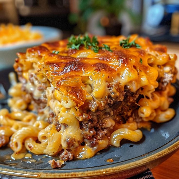 a close up of a plate of food with noodles and cheese on it, sitting on a table