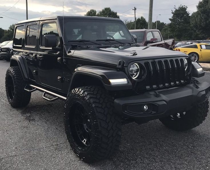 a black jeep parked in a parking lot