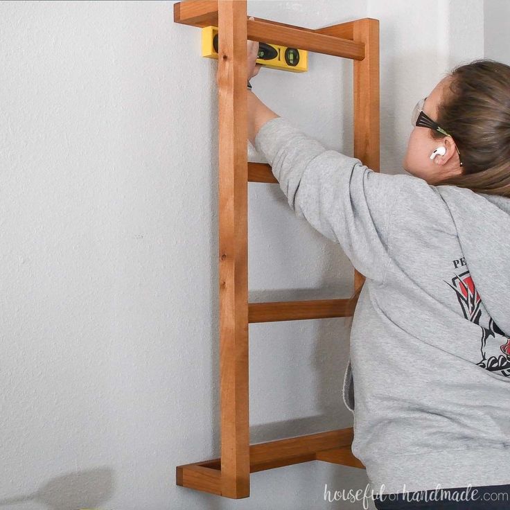 Make your home feel cozy with a DIY blanket ladder. Diy Blanket Rack For Wall, Blanket Ladder Attached To Wall, Blanket Shelf On Wall, Blanket Ladders Diy, Diy Blanket Holder On Wall, Blanket Ladder Wall Mount, Diy Wall Blanket Holder, Diy Blanket Holder, Wall Mounted Blanket Storage