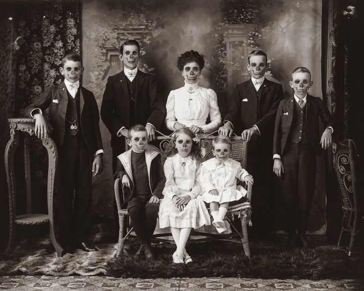 an old black and white photo of a family posing for a group shot in formal attire