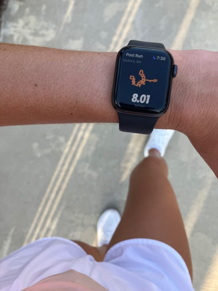 a person wearing a watch on their arm with an app on it's wrist