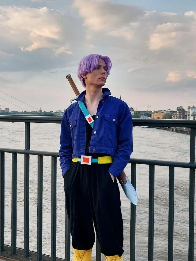 a man with purple hair and yellow boots is holding a baseball bat