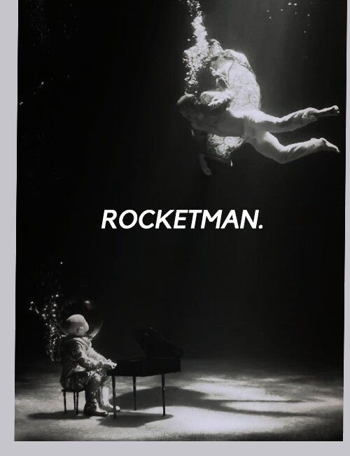 a black and white photo of a man sitting in a chair under water with the words rocketman above him