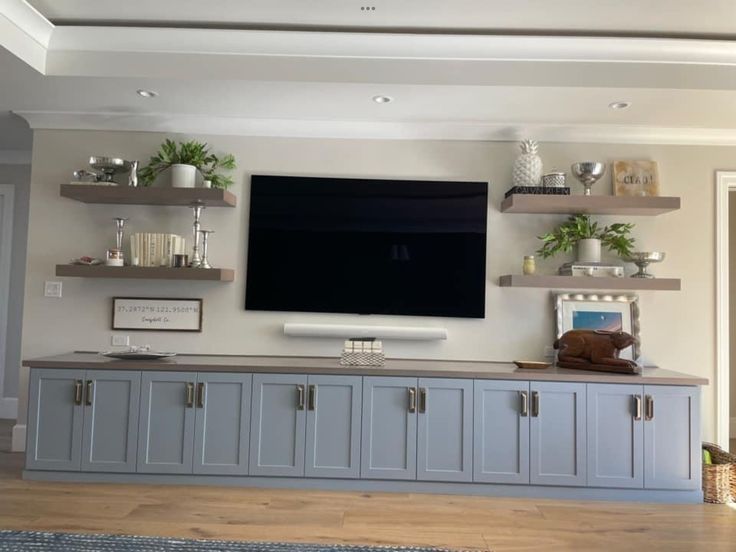 a large flat screen tv mounted to the side of a wall in a living room