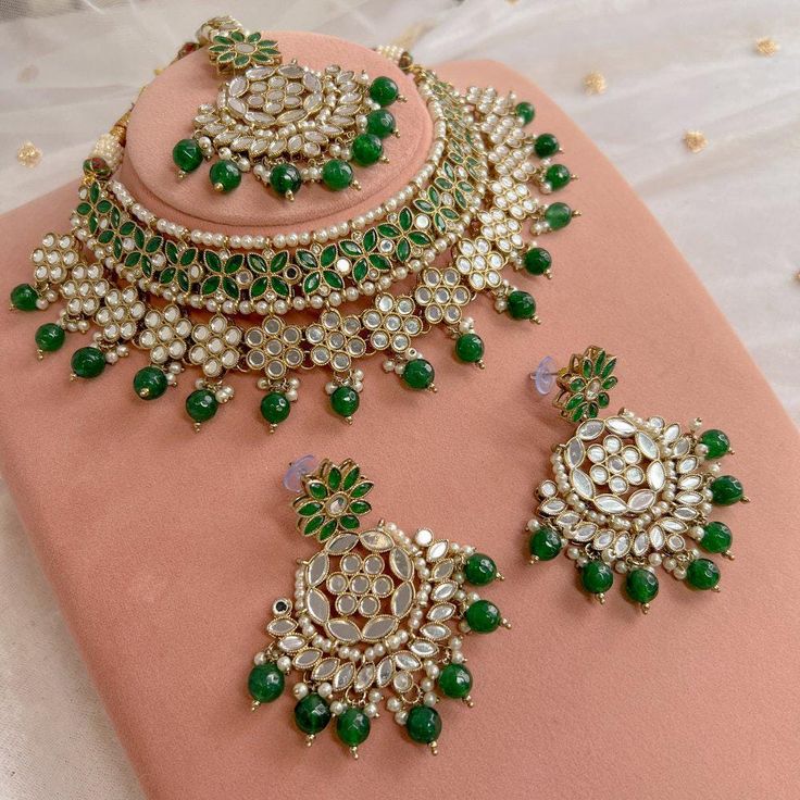 Antique gold necklace set with glass mirror stones and green glass beads.  Necklaces adjustable to fit. Includes lightweight  2.5 inch length Earrings and 2 inch elegant tikka with 3 inch hair chain attacked.  Ready to ship with gift box. Green Aesthetic Necklace, Adjustable Green Jewelry For Diwali, Green Jewelry With Mirror Work For Festivals, Green Jewelry With Mirror Work For Diwali, Green Bollywood Jewelry With Mirror Work, Green Kundan Necklace With Mirror Work As Gift, Green Kundan Necklace With Mirror Work For Celebration, Green Kundan Jewelry Sets As Gift, Green Kundan Jewelry Sets For Gifts