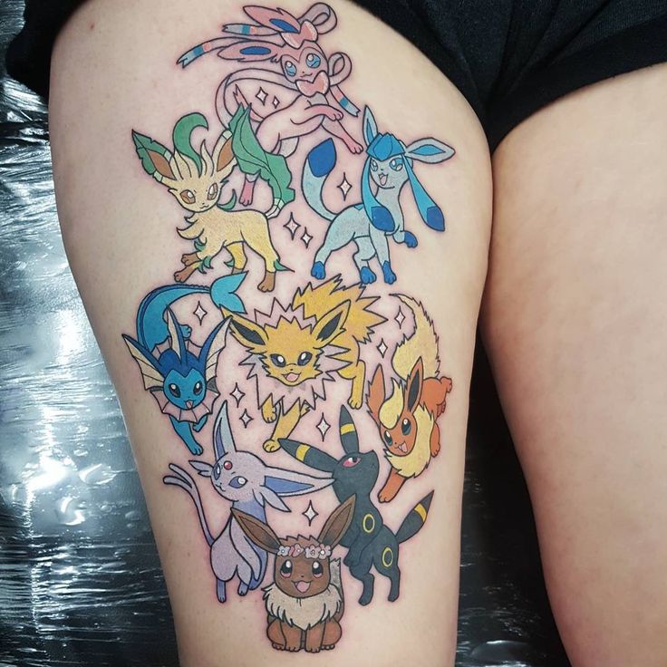 a woman's thigh with pokemon tattoos on it