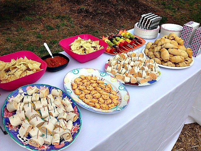 a table topped with plates and bowls filled with different types of food on top of it