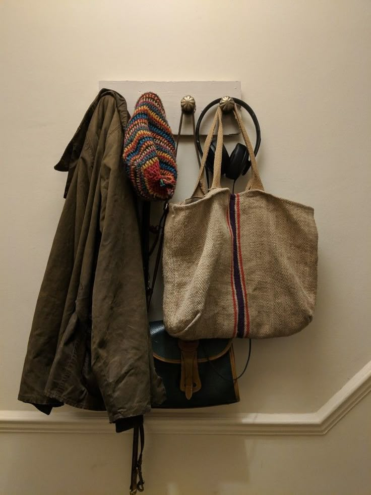 an assortment of purses hanging on a wall