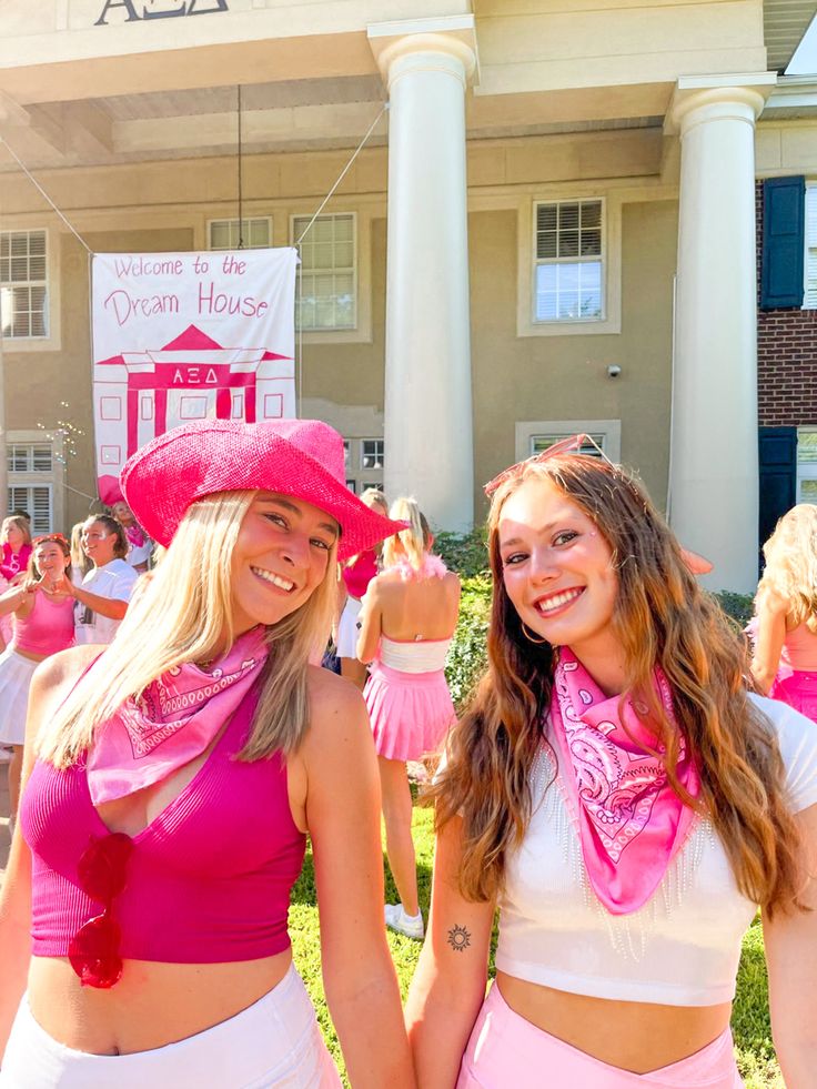 two women in pink and white outfits standing next to each other