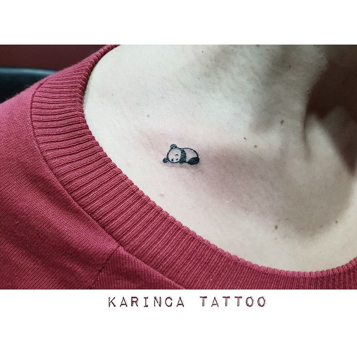 a small panda bear tattoo on the back of a woman's neck and chest