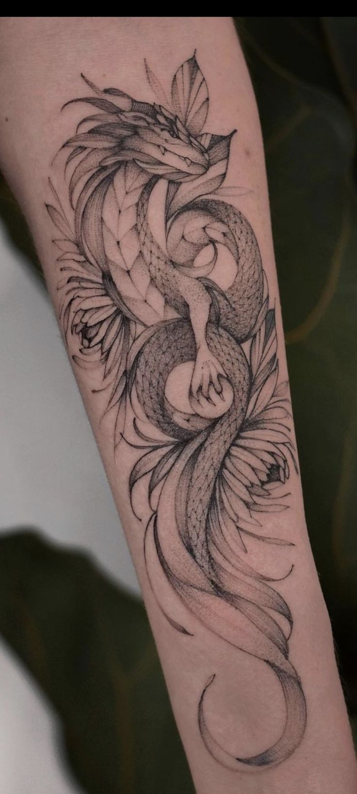 a woman's arm with a tattoo on it and a fish in the middle