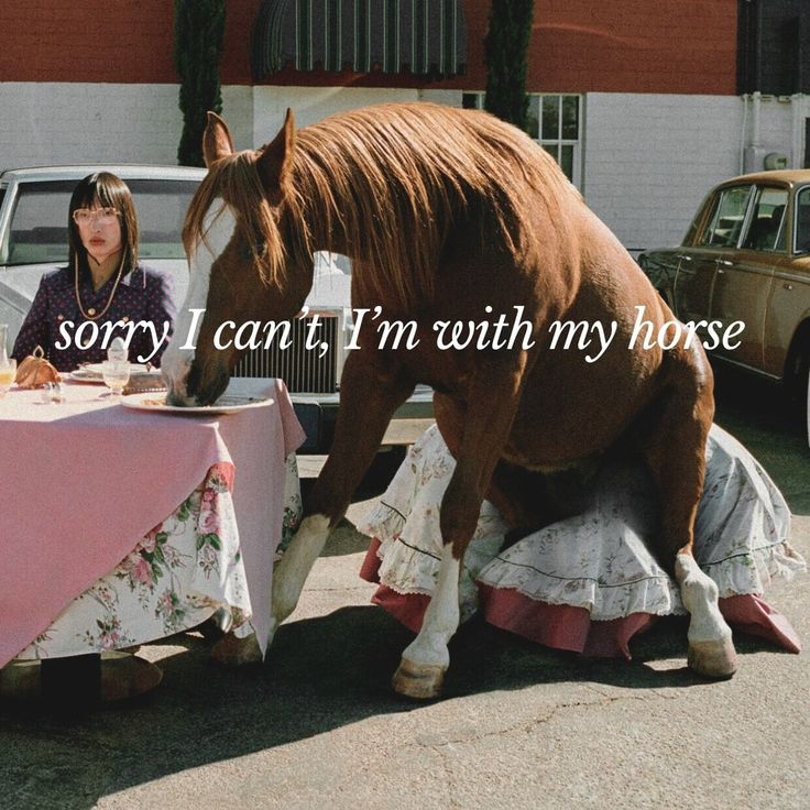 a woman sitting at a table with a horse