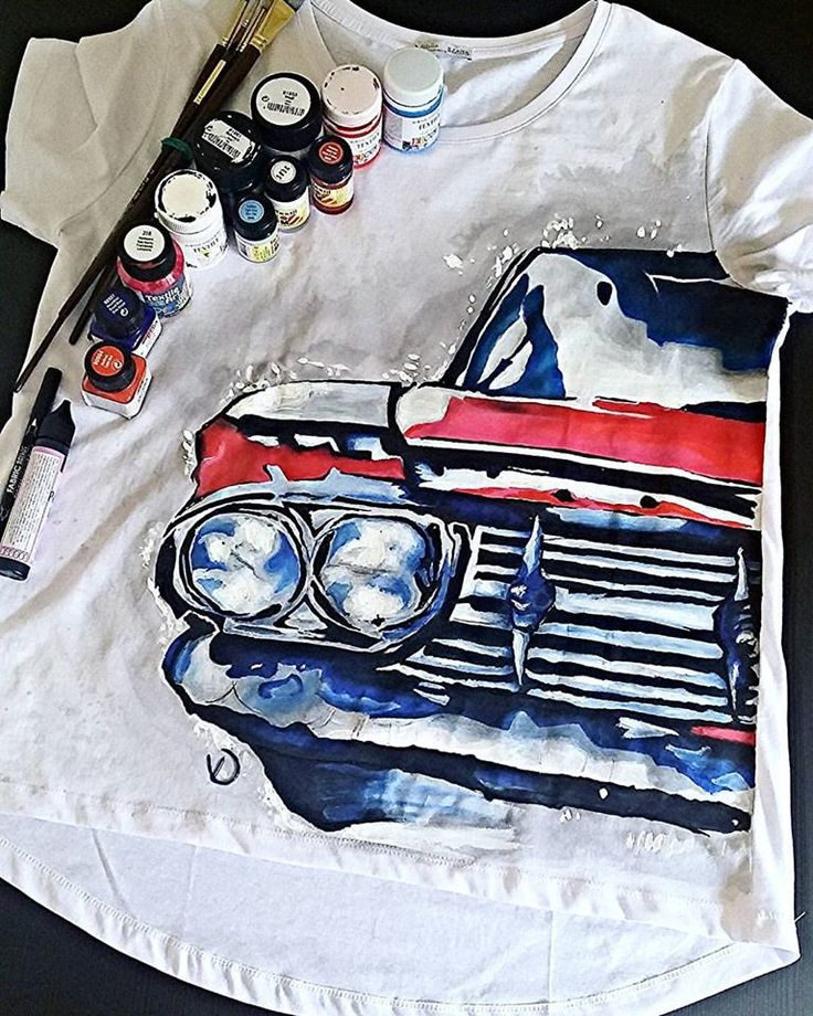 a t - shirt with an image of a car painted on it and paint supplies