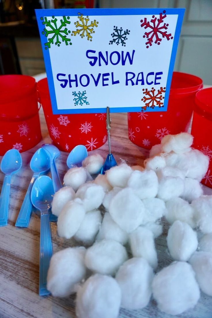 snow shovel race cups and spoons on a table with cotton balls in the middle