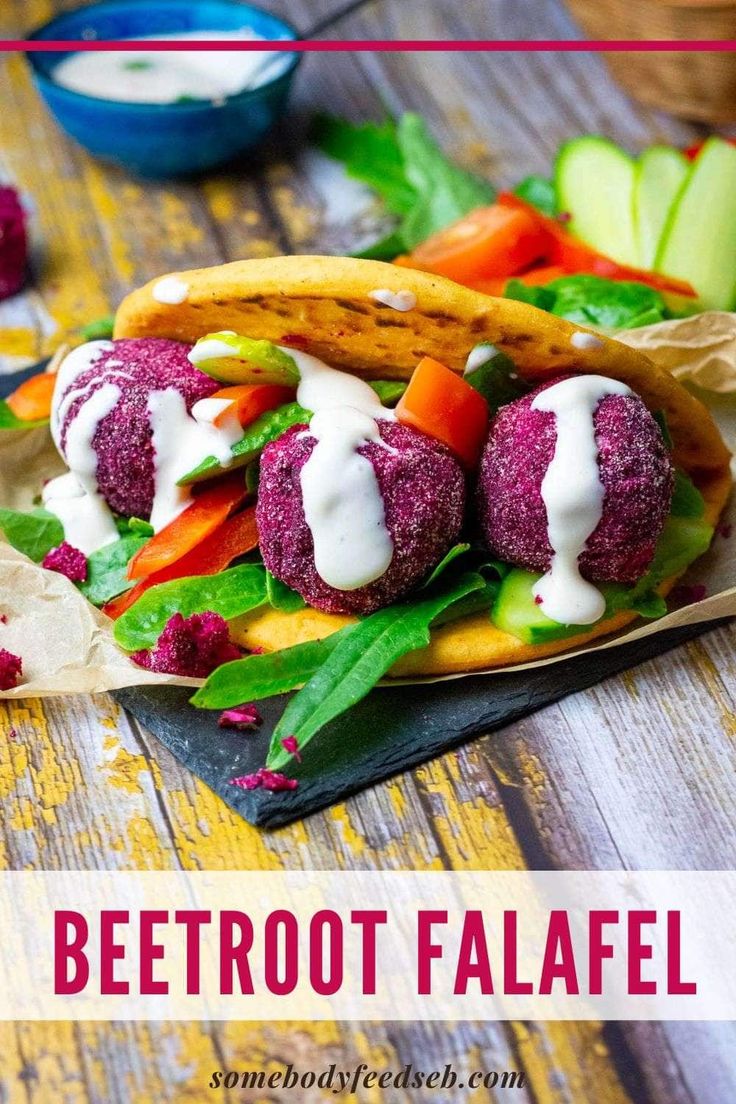 beetroot falafe with ranch dressing and pita bread on a wooden table