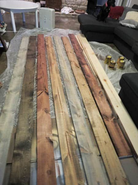 several pieces of wood are laid out on the floor to be used as a table