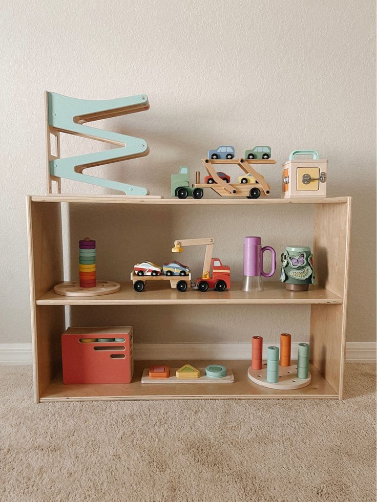 a wooden shelf filled with toys on top of carpet