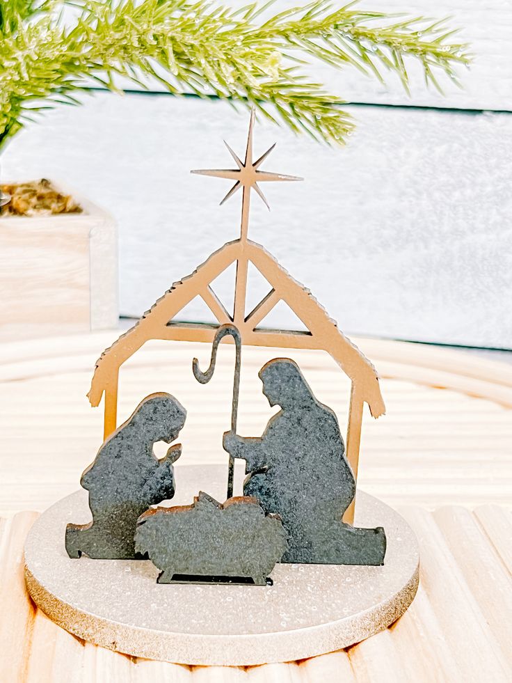 a nativity scene with two figurines and a star on top of it