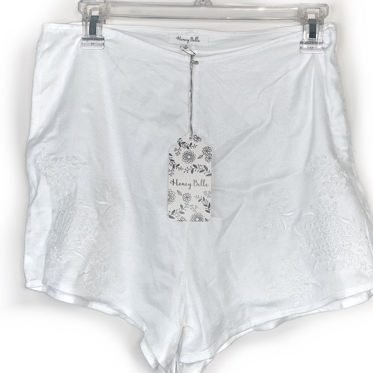 Honey Belle White Shorts With Embroidered Design. Lined With High-Rise Style. White Shorts Size Medium. Features Side Zipper. Approx. Measurement: 14” Waist. 100% Viscous/ Lining: 100% Cotton. Sgg0047 Summer Loungewear Bottoms With Floral Embroidery, Summer Cotton Shorts With Floral Embroidery, Floral Embroidered Cotton Summer Shorts, High Waist Cotton Bottoms With Floral Embroidery, High Waist Embroidered Cotton Bottoms, Fitted Beach Bottoms With Floral Embroidery, High-waist Embroidered Cotton Bottoms, White Cotton Shorts With Floral Embroidery, Embroidered Cotton Bottoms