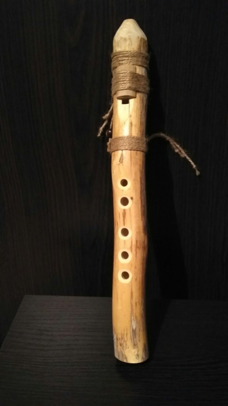 a wooden instrument with strings and holes in it