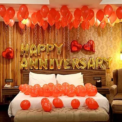 a bedroom decorated with balloons and streamers for an anniversary party or special occasion to celebrate