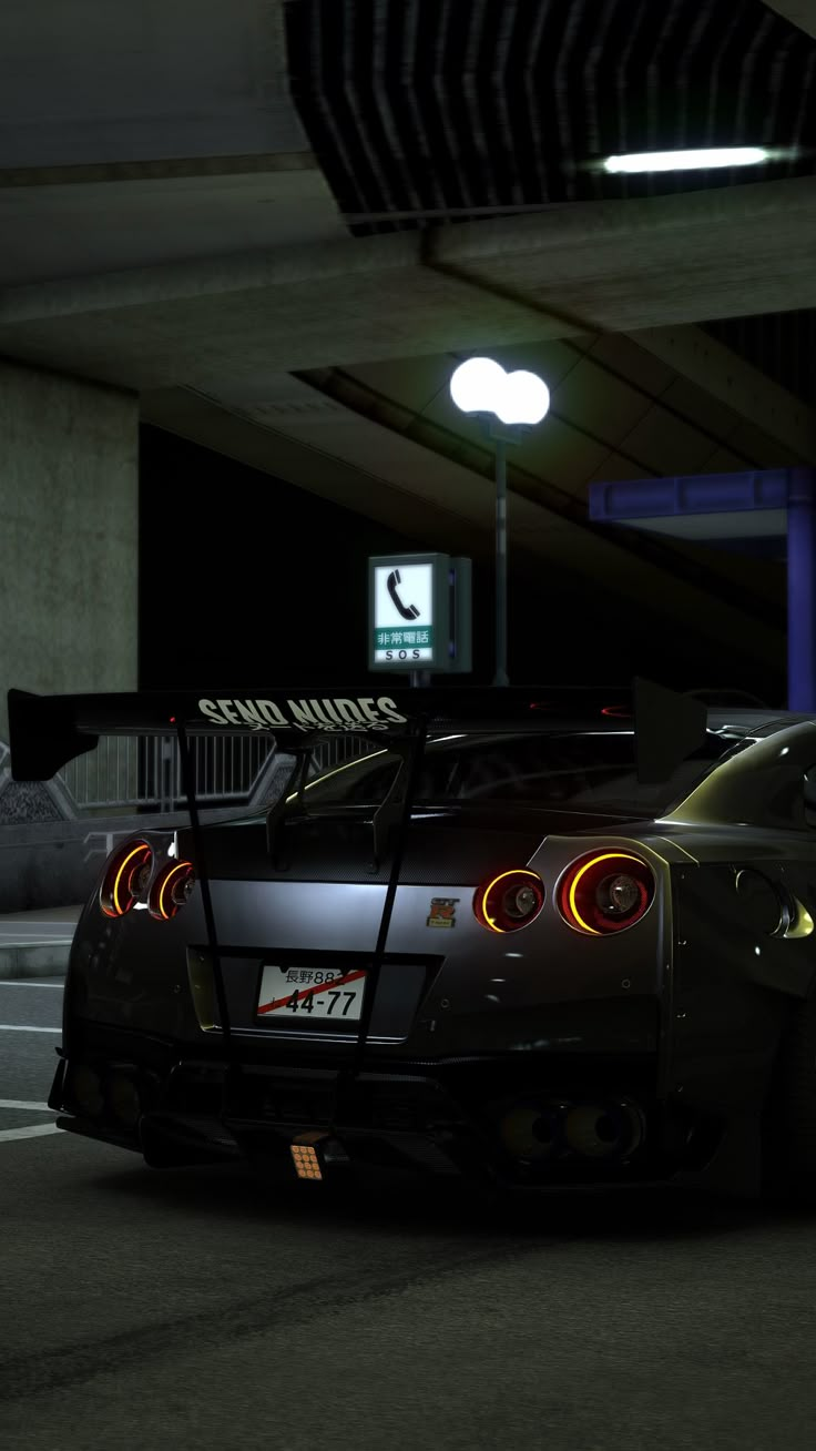 a black sports car parked in a parking garage