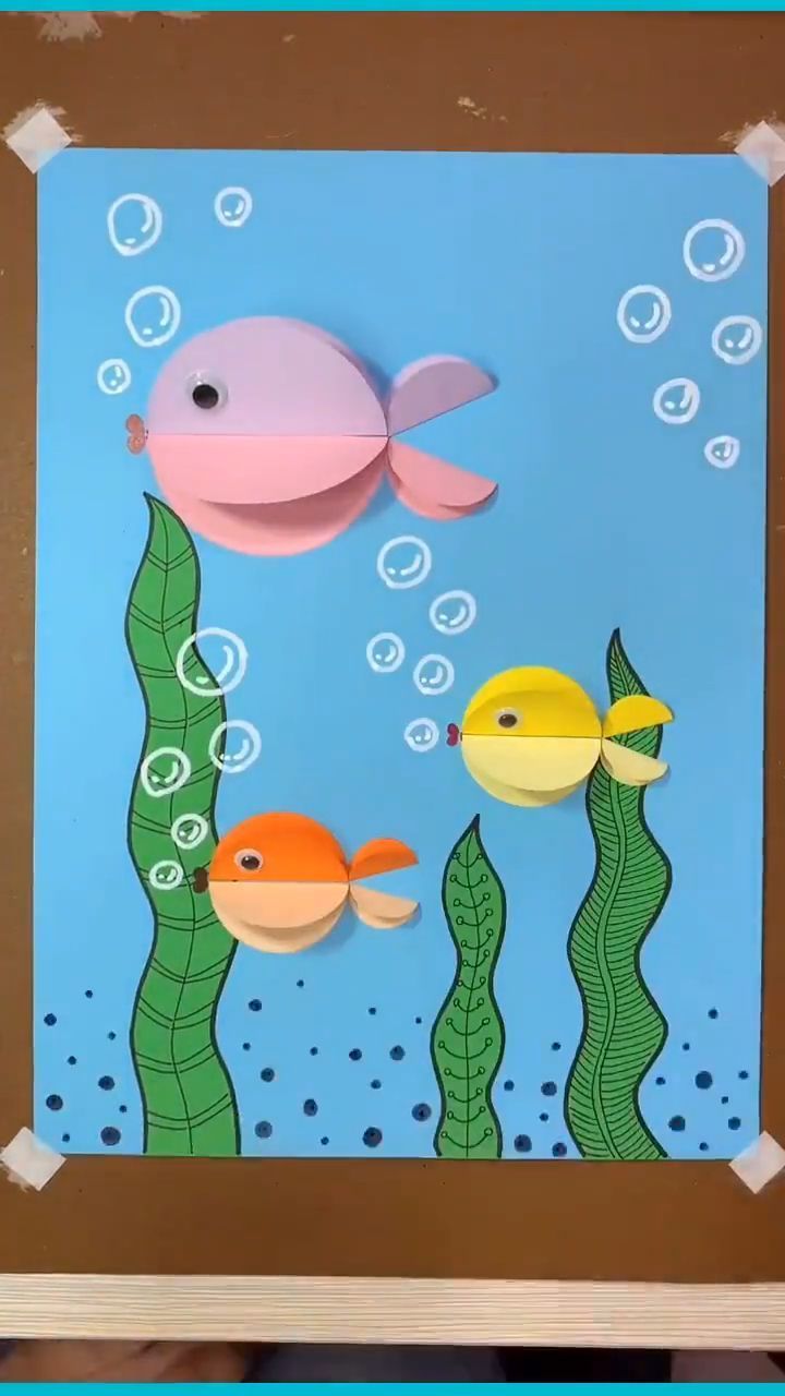 paper cut out of an ocean scene with fish and bubbles