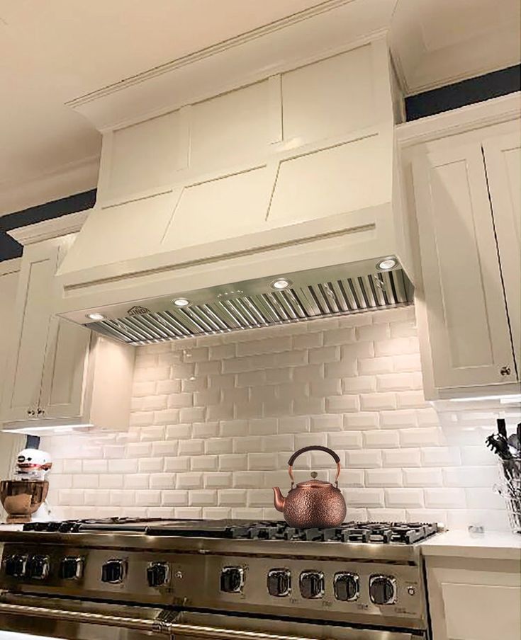 a stove top oven sitting inside of a kitchen