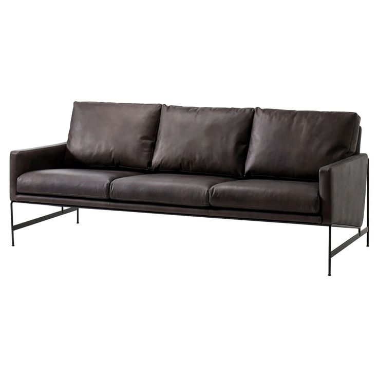 a black leather couch sitting on top of a metal frame